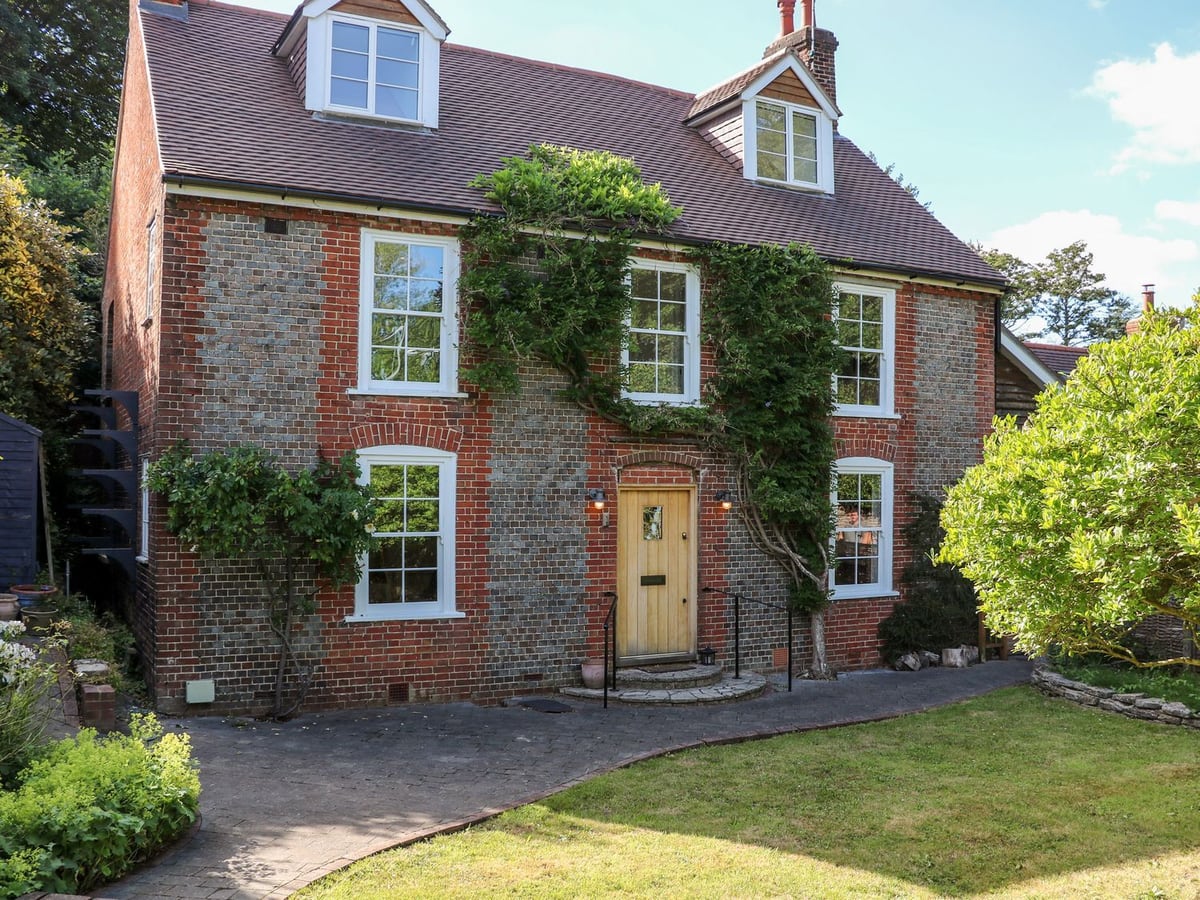 Bailey Cottage two-storey brick exterior with timber front door and planted garden