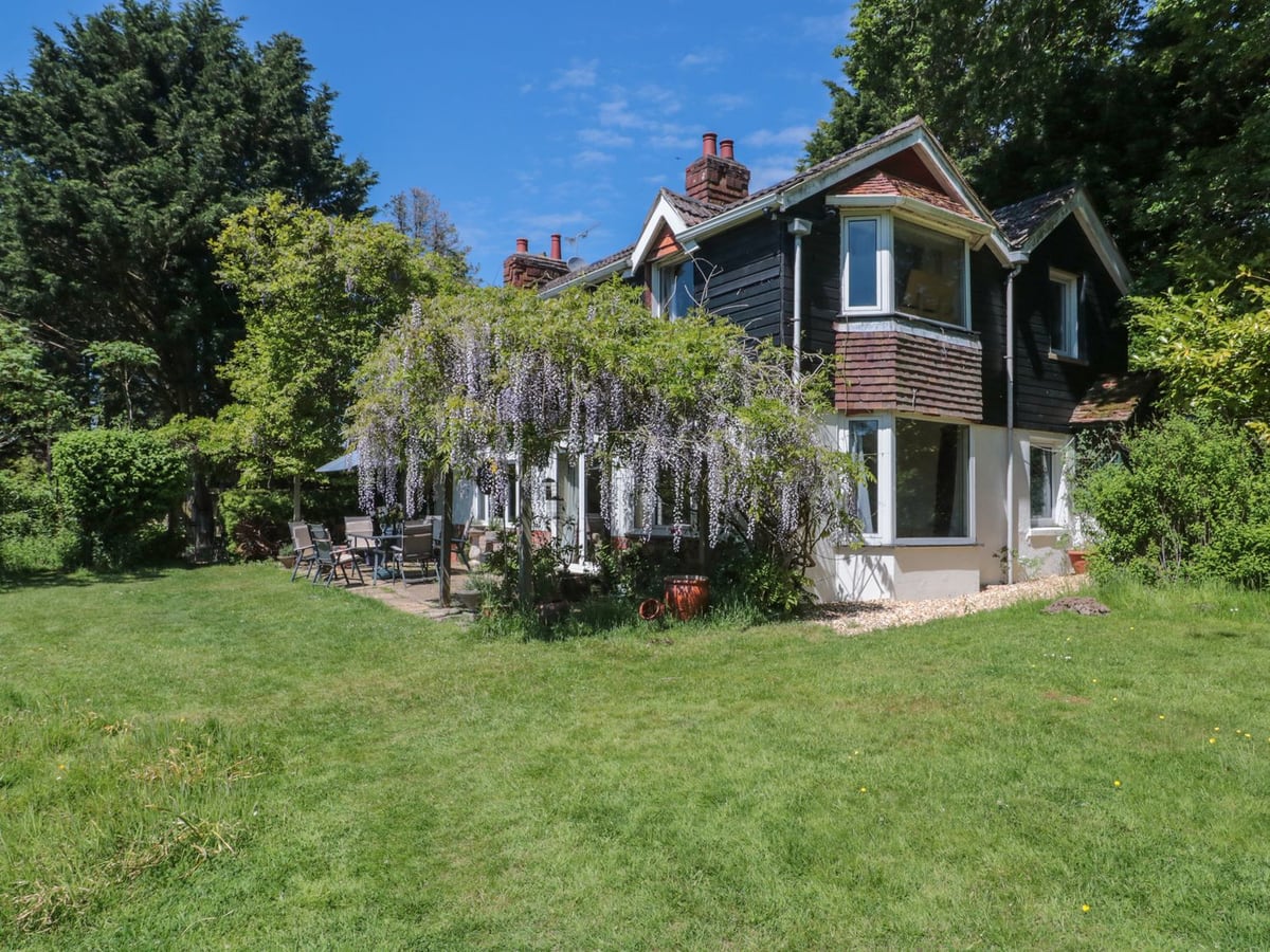 Brook Farm near Ringwood exterior with lawn, wisteria and garden seating