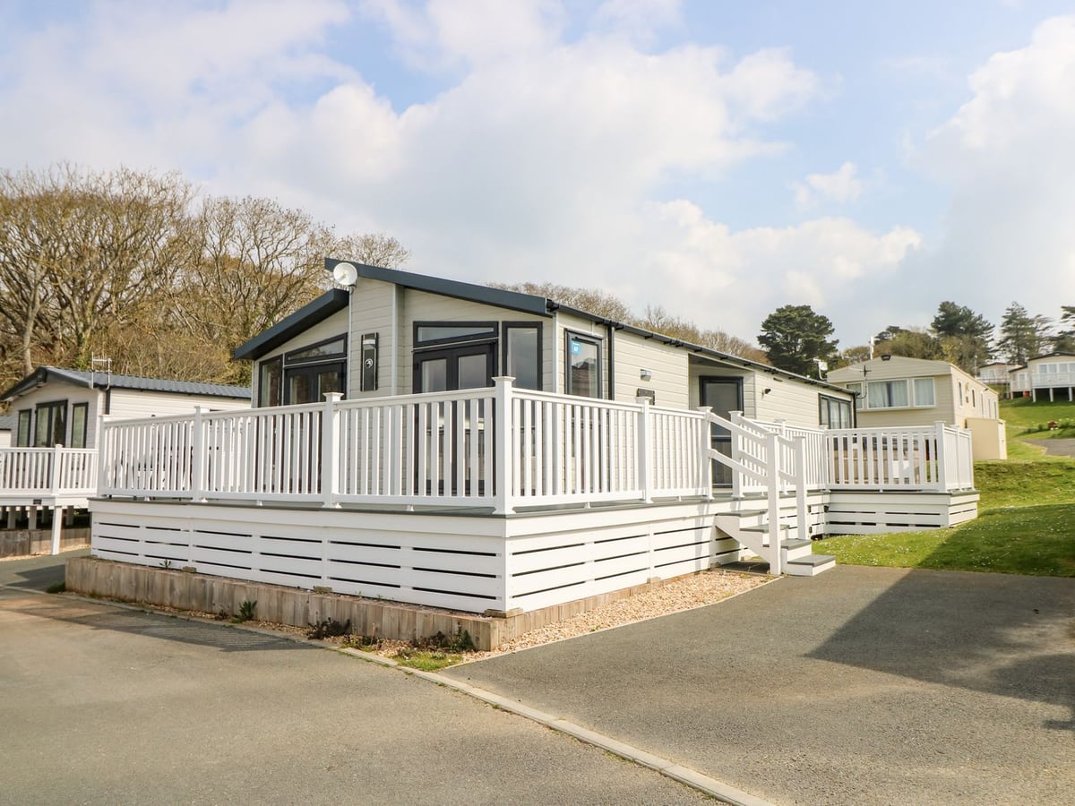Crosswinds 67 lodge exterior with raised wraparound decking on the holiday park