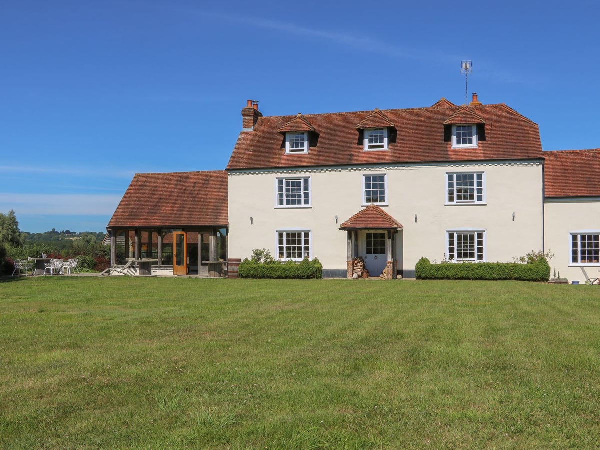 Groomes Country House exterior with lawn and countryside beyond