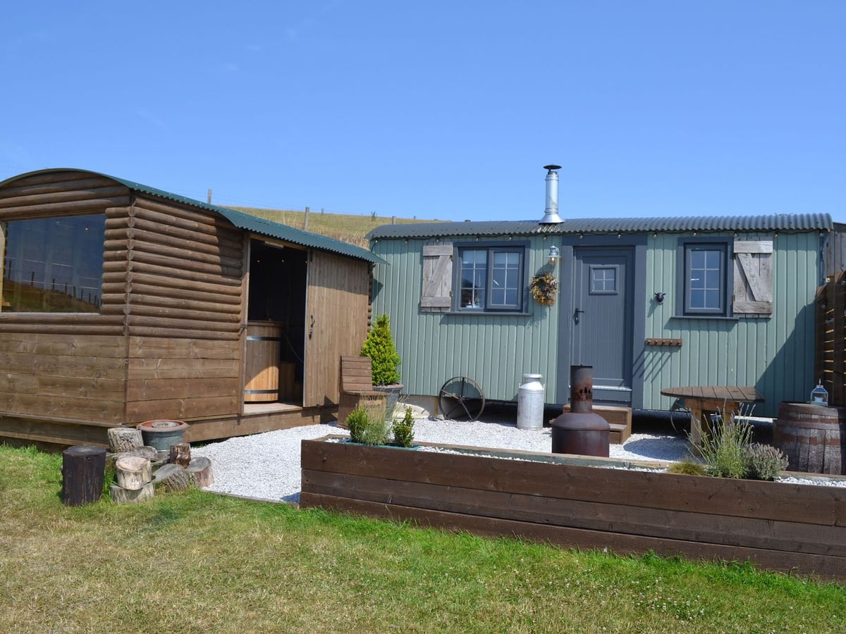 Heather Hut at Copy House Hideaway with a gravel patio and timber hot tub shelter