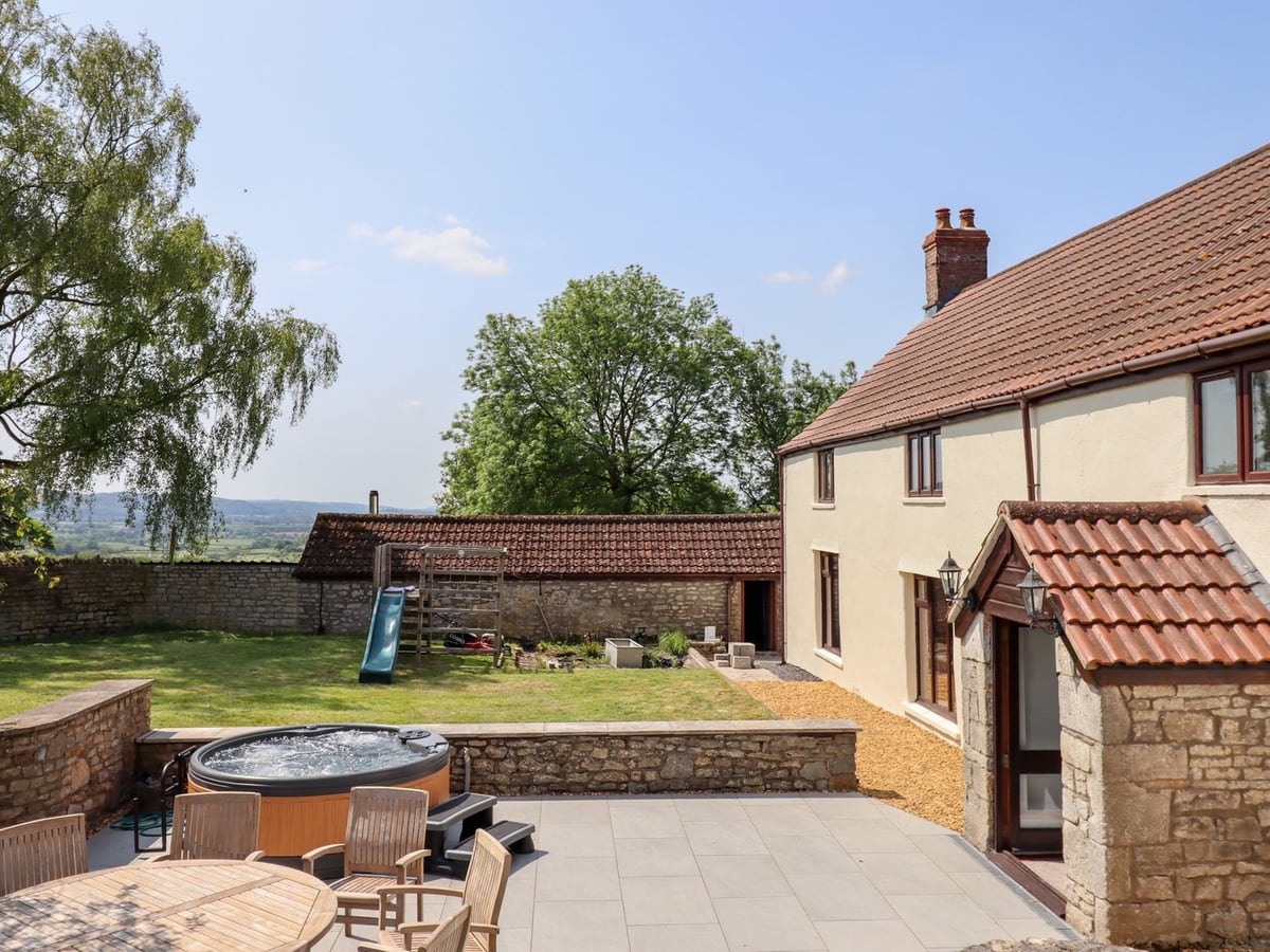 Nempnett Farmhouse patio with hot tub, lawn and play slide by the house