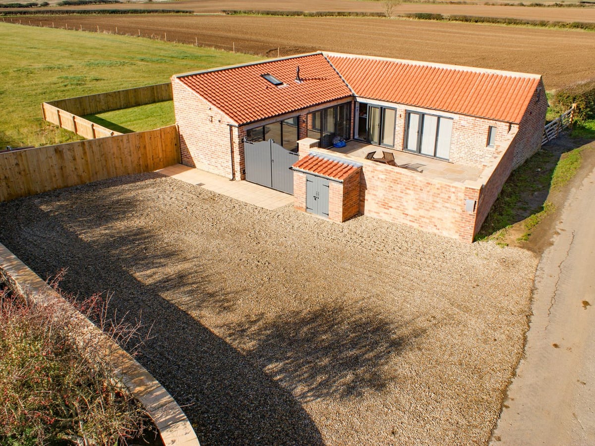 Brick barn cottage with fenced lawn, patio and open fields around Owl View