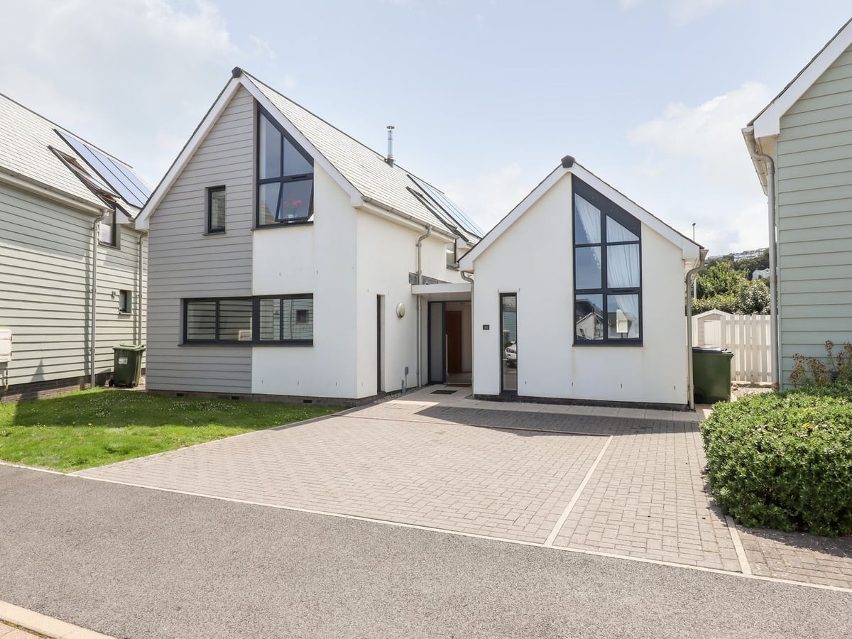 Two white gables with tall dark windows beside neighbouring houses at Pebble Ridge View