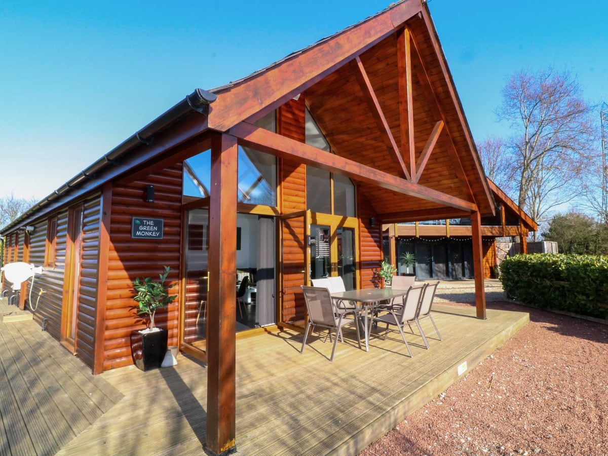 Timber exterior of The Green Monkey with a covered dining deck and glazed doors